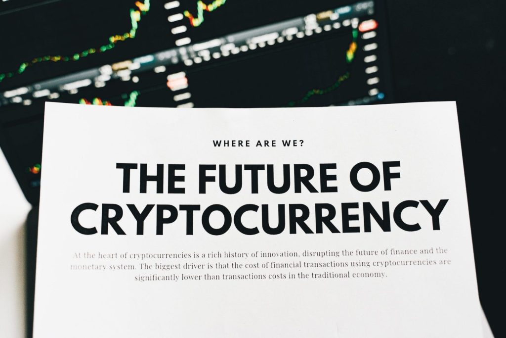 Close-up of a finance article on cryptocurrency with charts in the background.